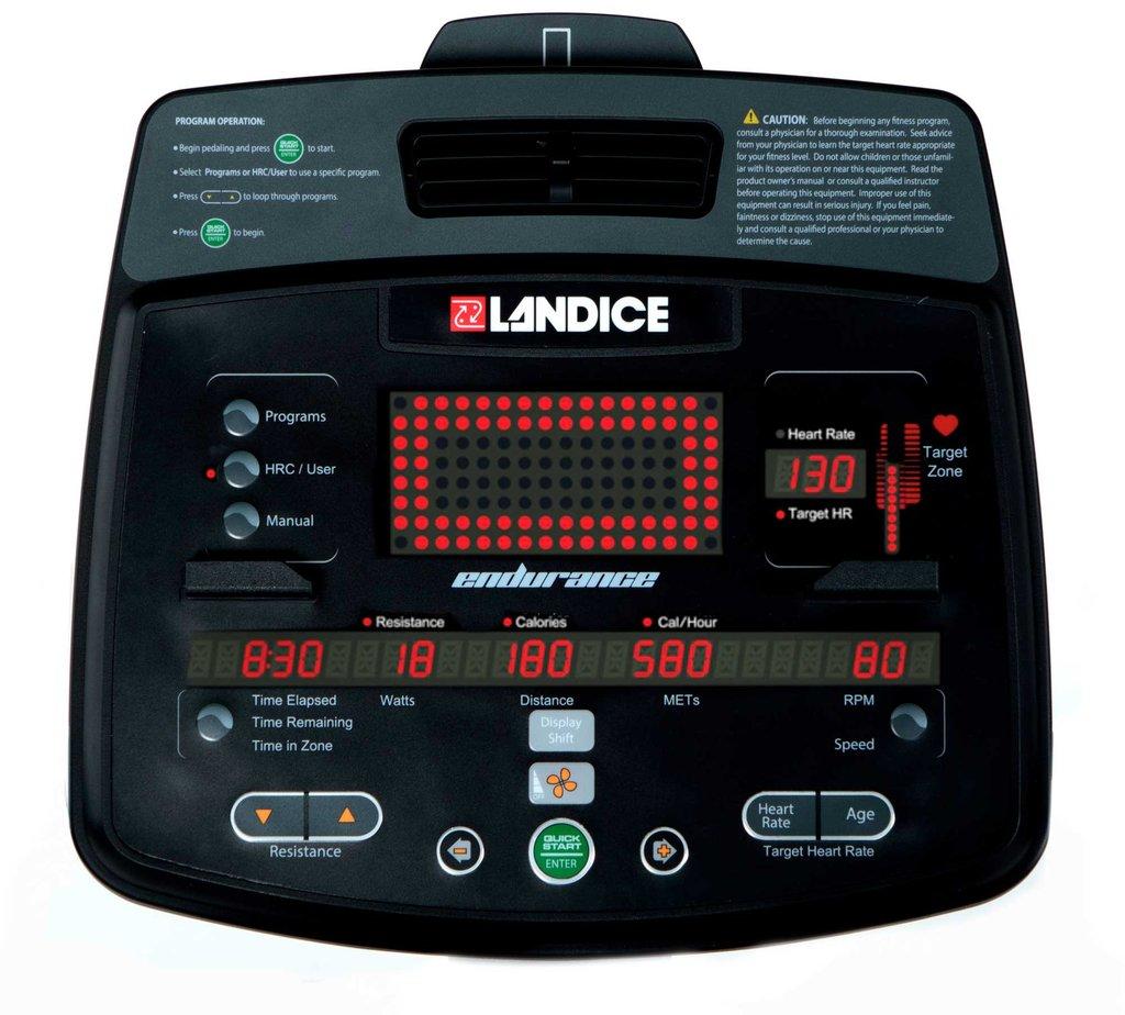 Black exercise bike display console with red LED's.