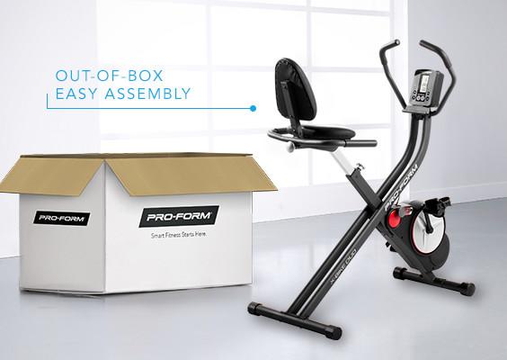 An exercise bike shown next to its box to display ease of assembly.